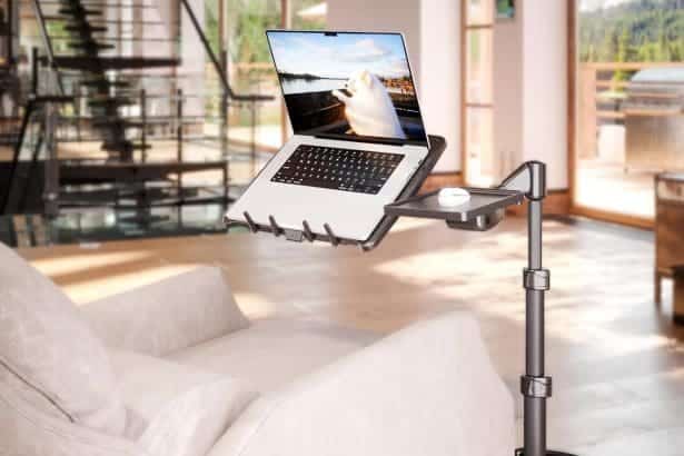 Adjustable LEVO G2 Deluxe Laptop Stand on wheels next to a sofa