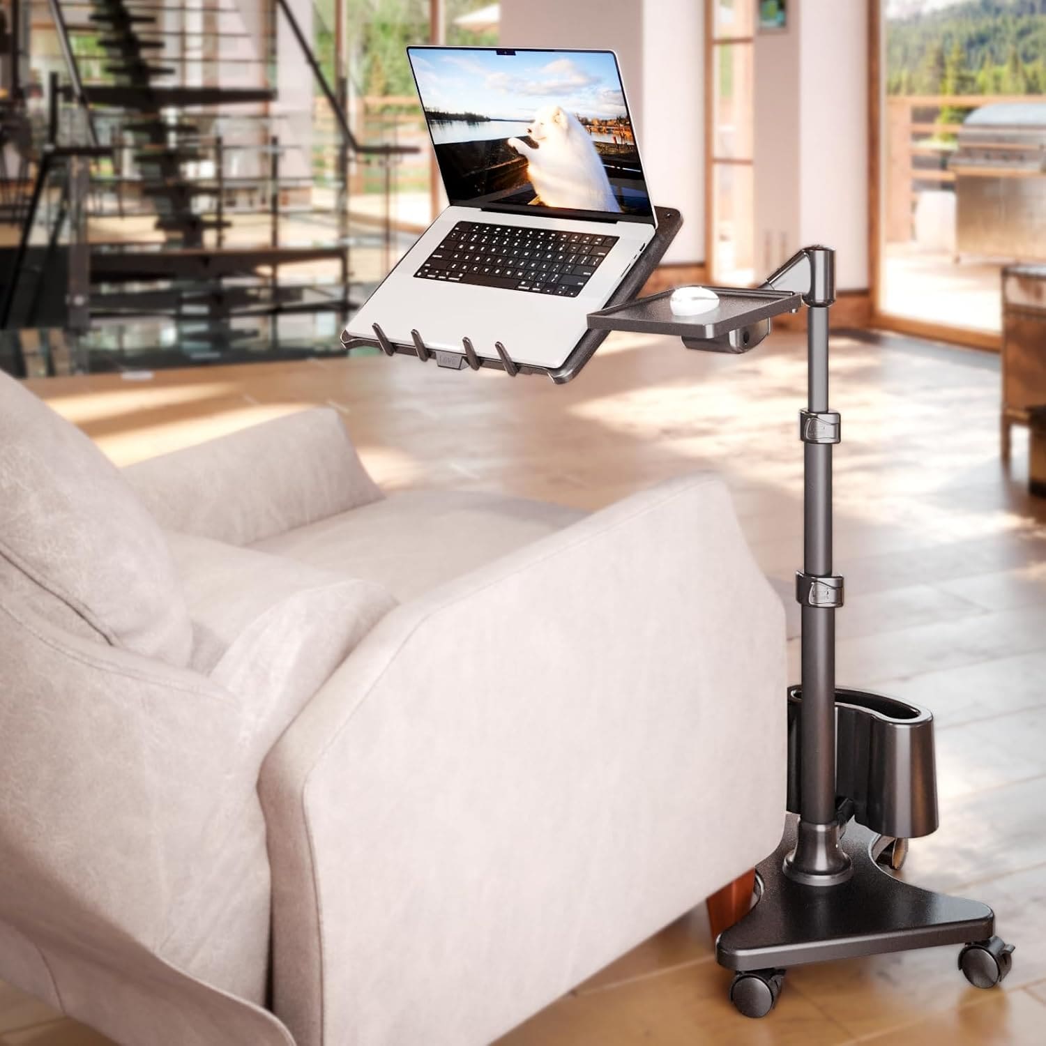 Adjustable LEVO G2 Deluxe Laptop Stand on wheels next to a sofa